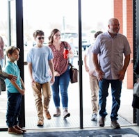 a group of people standing in front of a door