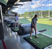 a group of people playing golf in an indoor arena